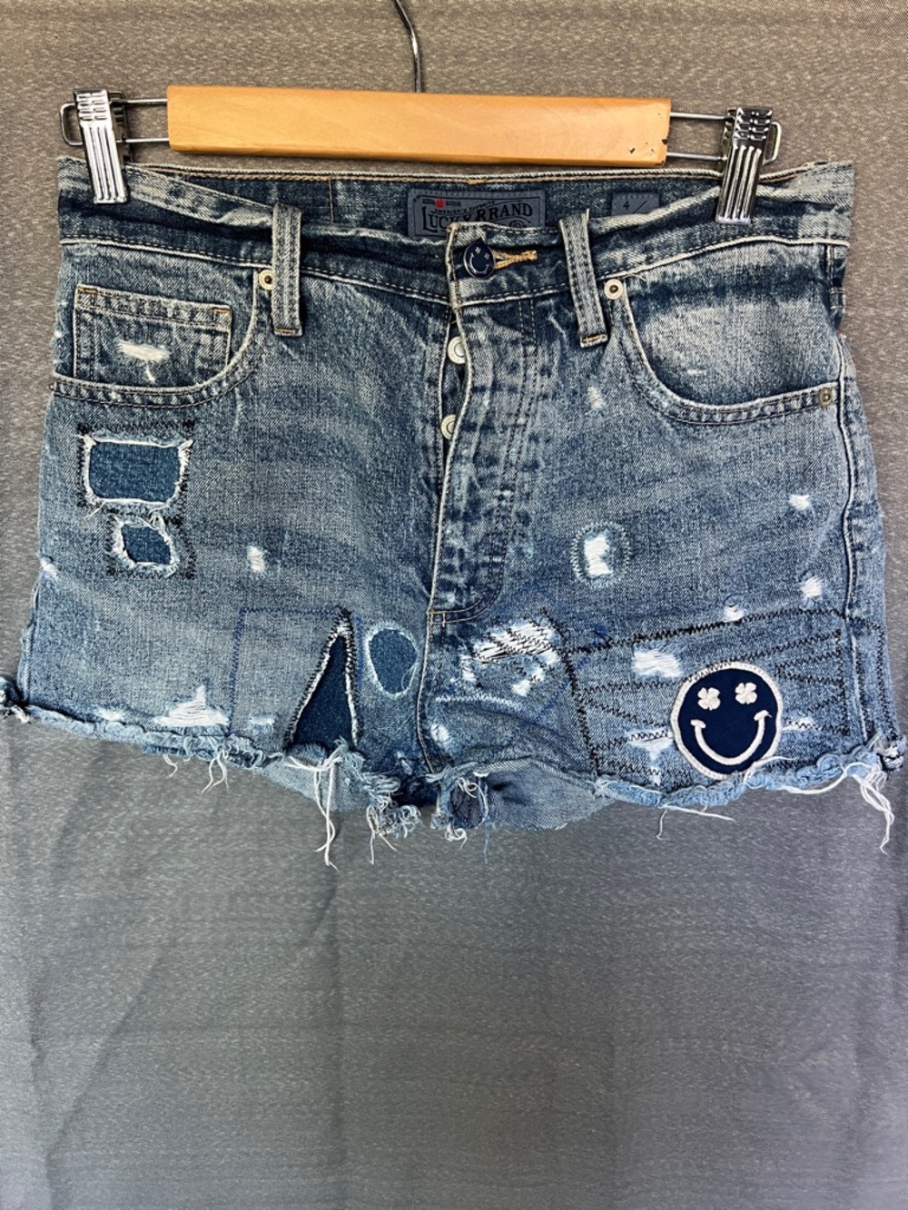 Lucky Brand Blue Distressed Denim Shorts w/Smiley Patch front/back pockets 27”